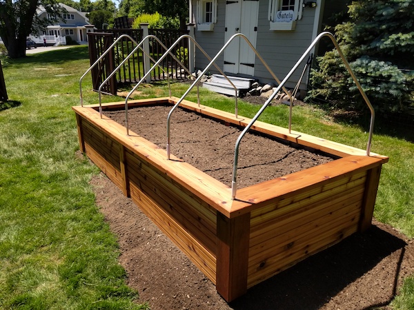 a raised garden bed with a row cover