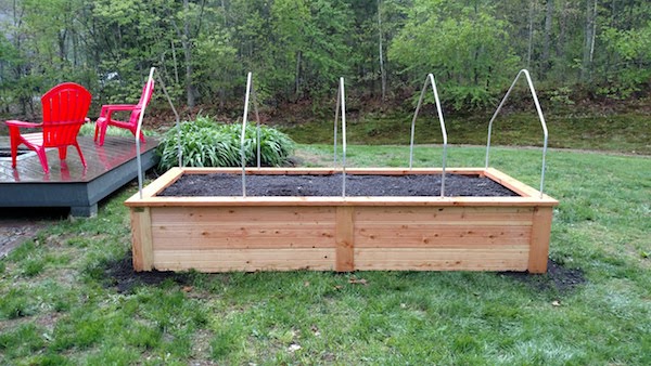 close up view of a raised garden box with row cover